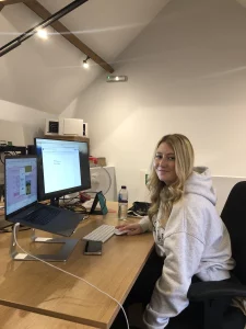 Image of Izzy on her work experience at her desk on her laptop